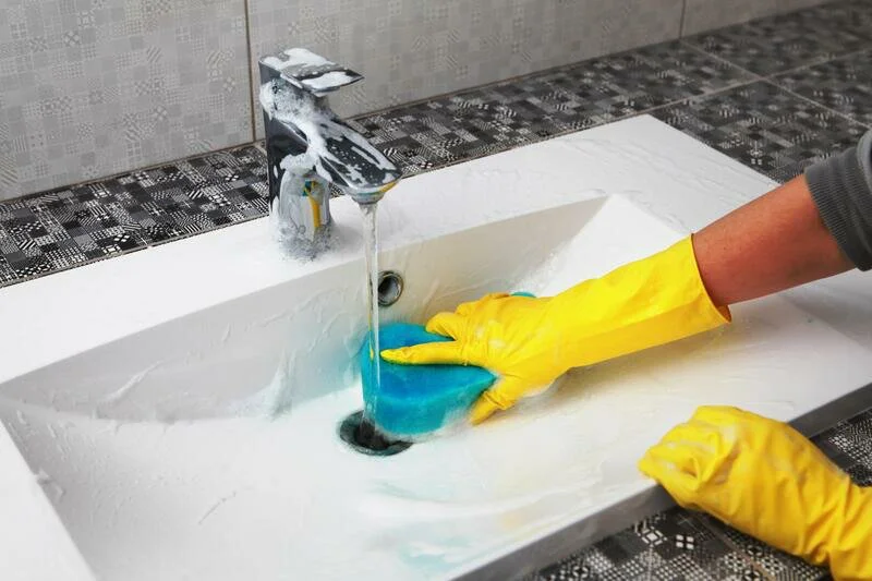 house cleaner doing sink cleaning